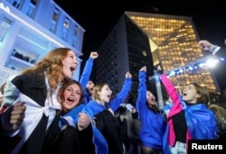 Supporters of the Georgian Dream party celebrate at the party's headquarters after the announcement of exit poll results in parliamentary elections, in Tbilisi, Georgia, Oct. 26, 2024.