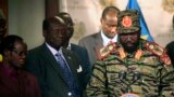 South Sudan's President Salva Kiir (R) addresses a news conference at the Presidential Palace in capital Juba December 16, 2013, a day after fighting erupted in the capital. Government officials said the unrest was triggered by a failed coup, a premise that has been widely rejected by the international community, and a report by an African Union Commission of Inquiry, released on Oct. 27, 2015. 