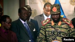 FILE - South Sudan's President Salva Kiir, right, addresses news conference at Presidential Palace, Juba, Dec. 16, 2013.