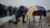 A man mourns next to the coffin containing the body of Anton Spitsyn, a Ukrainian serviceman killed fighting Russian troops, during a funeral ceremony in Kharkiv, Ukraine, on Feb. 5, 2025.