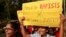FILE - Indian students hold placards and shout slogans during a protest organized to create awareness of gender-based violence against women in Mumbai, Dec 10, 2014. 
