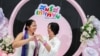 An LGBTQ+ couple poses for a photo after receiving official marriage certificates, as Thailand's marriage equality bill came into effect, in Bangkok, Jan. 23, 2025.