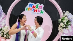 An LGBTQ+ couple poses for a photo after receiving official marriage certificates, as Thailand's marriage equality bill came into effect, in Bangkok, Jan. 23, 2025.