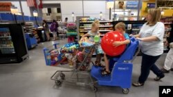 FILE - A family shops at the Wal-Mart Supercenter in Springdale, Arkansas, June 4, 2015. Consumer spending that powers most U.S. econometric activity jumped a strong one percent in April, the biggest gain in about six years.