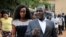 FILE - Wife Barbara Kyagulanyi of pop star and lawyer Asuman Basalirwa attempt to gain access to the military court trial of lawmaker, pop singer and prominent critic of Uganda's government Kyagulanyi Ssentamu, whose stage name is Bobi Wine, in Gulu, northern Uganda, Aug. 16, 2018. 