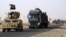 A convoy of Iraqi military vehicles heads toward Qayyarah base in northern Iraq, ahead of an expected offensive to retake Mosul from Islamic State militants, Oct. 15, 2016.