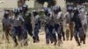 Police leavethe scene after throwing teargas at a house in Chitungwiza, Zimbabwe, Sunday, Nov. 6, 2011. The party of Zimbabwe's prime minister says 22 people were injured and property was destroyed after ruling party militant youths attacked hundreds of s