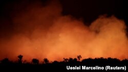 Smoke billows during a fire in an area of the Amazon rainforest on August 17, 2019. 