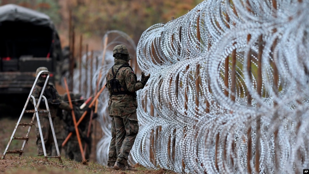 FILE - Polish soldiers lay razor wire along Poland's border with Russian in Wisztyniec, Poland, on Nov. 2, 2022. Polish Prime Minister Donald Tusk announced on May 18, 2024, that Poland would spend $2.5 billion to increase security along its border with Russia and Belarus.