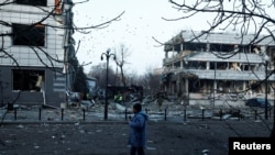 A man walks near the site of a Russian missile strike in Kyiv amid Russia's attack on Ukraine, Feb. 12, 2025. 