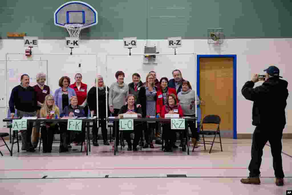 Voting precinct workers take a group photograph in Manchester, N.H., Feb. 11, 2020.
