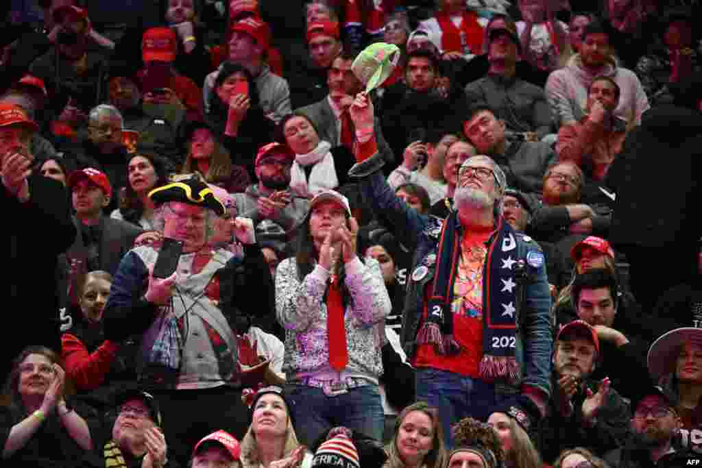 Supporters of President Donald Trump react as they watch a screen while Donald Trump is sworn in as the 47th president of the United States inside Capitol One Arena, in Washington, Jan. 20, 2025. 