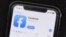 FILE - The social media application, Facebook is displayed on Apple's App Store, July 30, 2019. Facebook is launching a long-promised tool that lets users block the social network from gathering information about them on outside websites and apps.