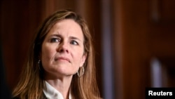 FILE - Judge Amy Coney Barrett, U.S. President Donald Trump's nominee to the Supreme Court, attends a meeting with U.S. Senator Kevin Cramer (R-ND) on Capitol Hill in Washington, Oct. 1, 2020.