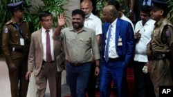 Marxist lawmaker Anura Kumara Dissanayake waves as he departs the election commission office after winning the Sri Lankan presidential election in Colombo, Sri Lanka, Sept. 22, 2024. (AP Photo/Eranga Jayawardena)