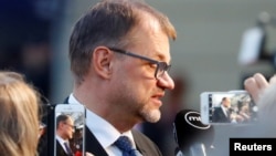 FILE - Finland's Prime Minister Juha Sipila talks to the media as he arrives for an informal meeting of European Union leaders, in Salzburg, Austria, Sept. 19, 2018.