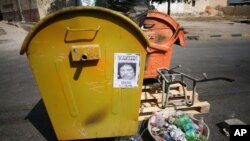 A Gadhafi "Wanted" sign on the side of a trash can in Tripoli.