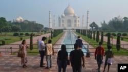 A small number of tourists visit as the Taj Mahal monument is reopened after being closed for more than six months due to the coronavirus pandemic in Agra, India, Sept.21, 2020.