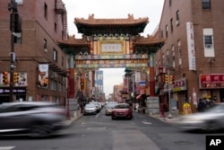 Evening traffic passes near the Chinatown neighborhood of Philadelphia, Sept. 18, 2024.