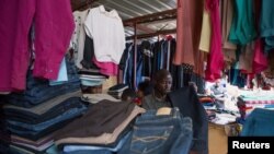 A man looks at clothing items in the Nyabugogo Market in Kigali, Rwanda, July 31, 2018. 