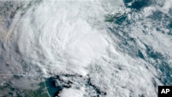This GOES-16 satellite image taken May 27, 2020, at 11:40 UTC and provided by the National Oceanic and Atmospheric Administration shows Tropical Storm Bertha approaching the South Carolina coast. (NOAA via AP)