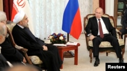 FILE - Russia's President Vladimir Putin (R) is seen meeting with his Iranian counterpart Hassan Rouhani during last year's Shanghai Cooperation Organization (SCO) summit in Bishkek, Kyrgyzstan, Sept. 13, 2013. 