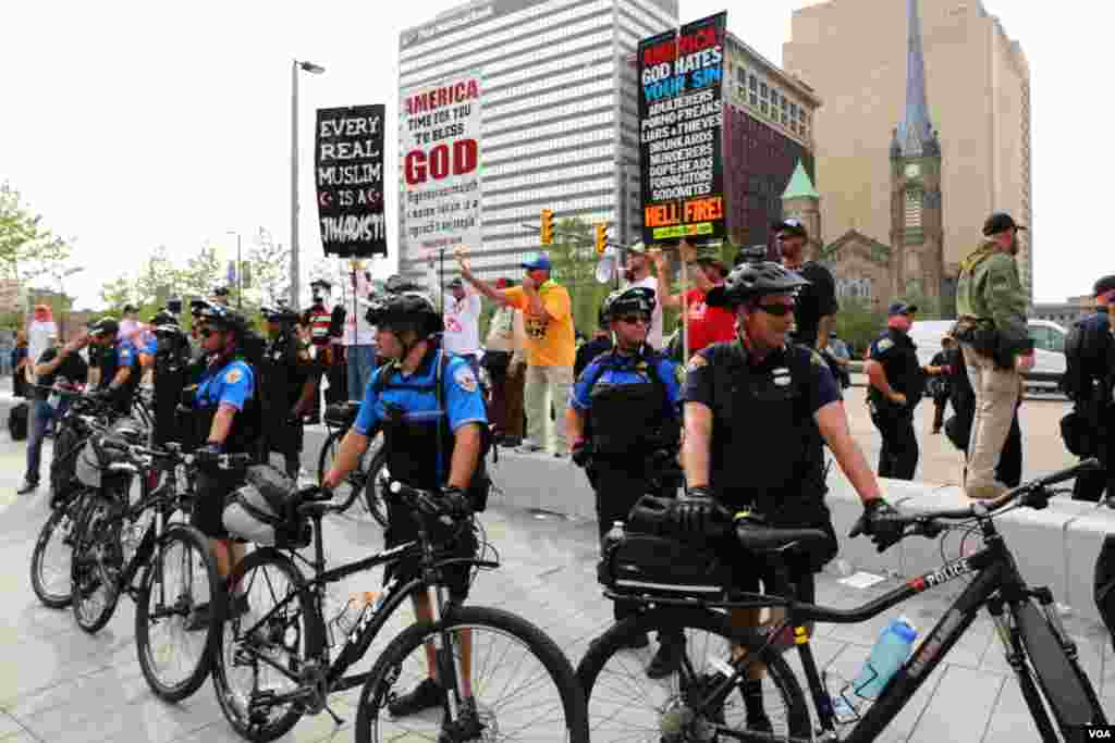 Outside the convention hall, protests continued for a fourth day but were contained by a large police presence. (M. Bush/VOA)