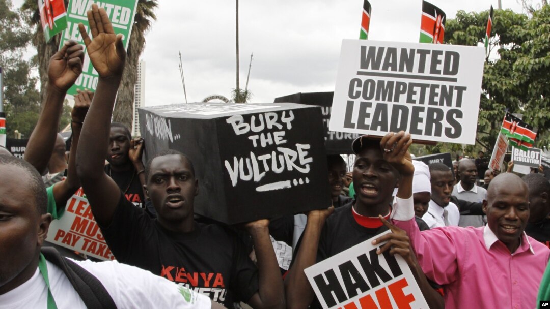 Youth groups protestors carrying replicas of 49 coffins saying bury the vulture seen in Nairobi, Kenya, June 28, 2012.