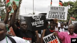 Youth groups protestors carrying replicas of 49 coffins saying bury the vulture seen in Nairobi, Kenya, June 28, 2012.