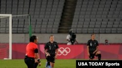  New Zealand players kneel before playing Australia in Group G play during the Tokyo 2020 Olympic Summer Games at Tokyo Stadium, Jul 21, 2021.