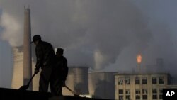 Cooling towers of a power plant and chemical factory in China. Among the 1,200 proposed coal-fired power plants 76 percent will be built in China and India, already among the top emitters of climate changing greenhouse gases. 