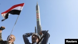 A Houthi follower carries a mock rocket in Sanaa on January 29, 2024, to show support for Houthi strikes on ships in the Red Sea and the Gulf of Aden, as well as solidarity with the Palestinians. (Khaled Abdullah/Reuters)