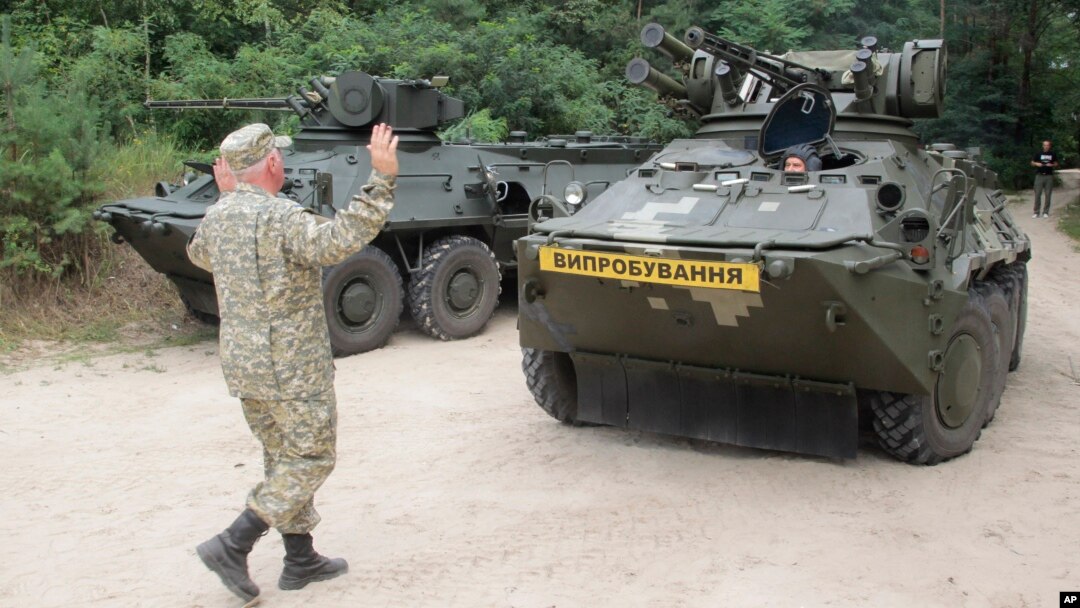 FILE - Ukrainian armored military vehicle BTR 3E takes position prior to a test firing at the shooting range of the Kiev's armored plant, in Kyiv,Ukraine.
