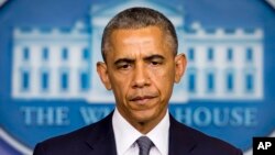 FILE- President Barack Obama listens to a question in the Brady Press Briefing Room of the White House, July 18, 2014. 