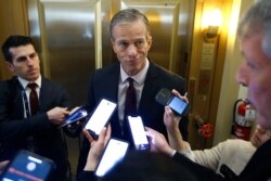 FILE - Sen. John Thune answers reporters' questions outside his office at the U.S. Capitol, Jan 29, 2020, in Washington.