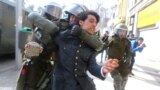 A demonstrator is detained during a rally to demand changes in the education system in Santiago, Chile.