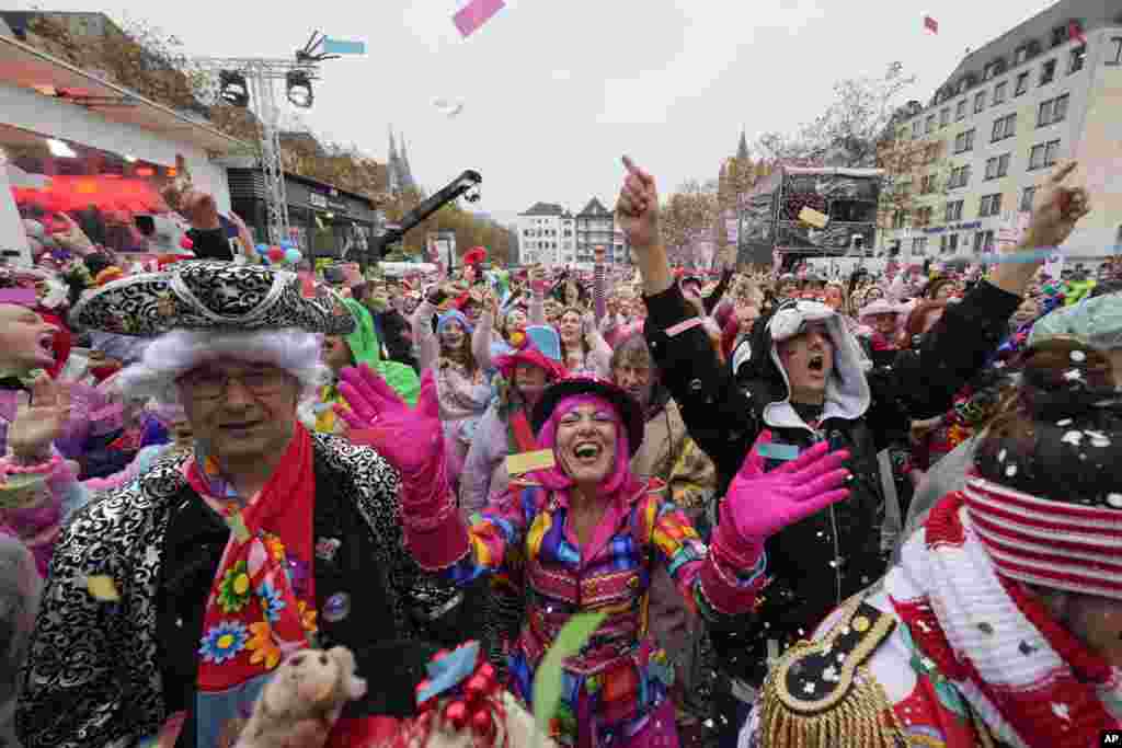 Costumed revelers celebrate at the central Heumarkt while tens of thousands of carnival fools take to the streets of Cologne, Germany, heralding the official start of the carnival season.