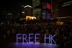 Protesters use illuminated letters to form a slogan as they attend a pro-democracy rally at Edinburgh Place in Hong Kong, Oct. 19, 2019.