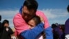 A person living in Mexico embraces a relative living in the U.S. during the annual "Hugs Not Walls" event on a stretch of the Rio Grande in Ciudad Juarez, Mexico, Nov. 2, 2024.