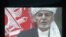 A screen shows the broadcast of Afghanistan's President Ashraf Ghani speaking during his inauguration as president, in Kabul, Afghanistan, March 9, 2020.