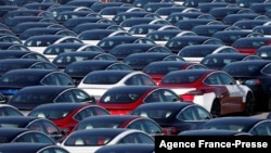 FILE - Newly manufactured Tesla electric cars are pictured in a storage area at The Western Docks in Southampton, Britain, April 20, 2020.