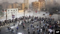 Egyptian protesters during clashes with anti-riot policemen in Suez, Egypt, Jan. 27, 2011