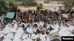 FILE - People fleeing gang violence take shelter at a sports arena, in Port-au-Prince, Haiti, Sept. 1, 2023. 