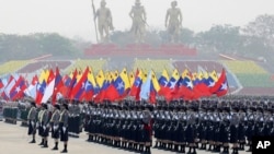 FILE - Military personnel participate in a parade on Armed Forces Day in Naypyitaw, Myanmar, March 27, 2021. 