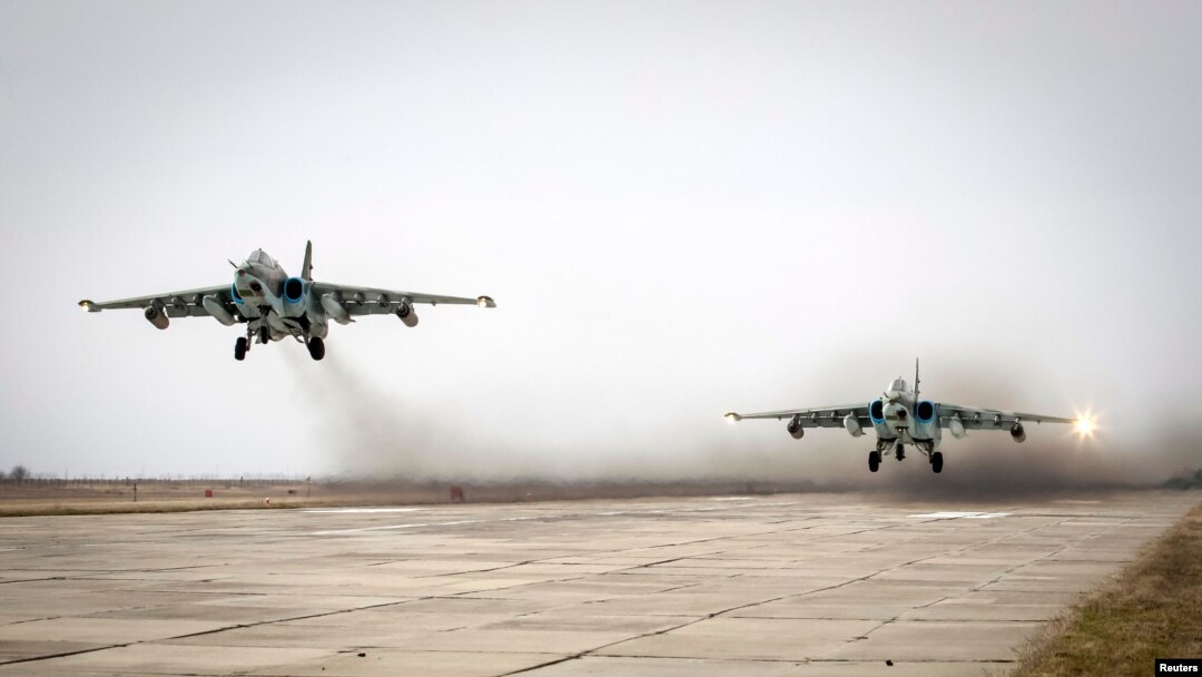 FILE - Sukhoi Su-25 jet fighters take off during a drill at the Russian southern Stavropol region, March 12, 2015. 