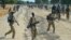 Sudan People's Liberation Army (SPLA) soldiers walk along a road in Mathiang near Bor, Jan. 31, 2014. 