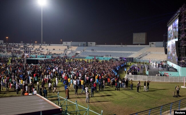 Migrant workers watch Qatar v Ecuador in the special fan zone in Doha, Qatar on November 20, 2022. (REUTERS/Marko Djurica)