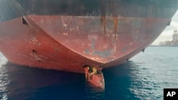 FILE: In this photo released by Spain's Maritime Safety and Rescue Society on Tuesday Nov. 29, 2022, three men are photographed on an oil tanker anchored in the port of the Canary Islands, Spain. The men were found on the Alithini II oil tanker at the Las Palmas port.