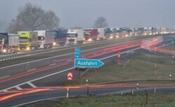 Trucks are jammed in the early morning on Autobahn 12 as they approach the German-Polish border crossing near Frankfurt-an-der-Oder, Germany, March 18, 2020.