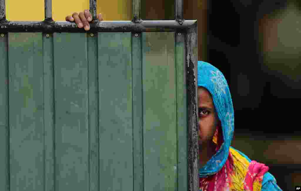 A Sri Lankan Muslim woman looks out on the street in Aluthgama in Sri Lanka.&nbsp; At least three Muslims were killed in a clash against a right-wing Buddhist group.